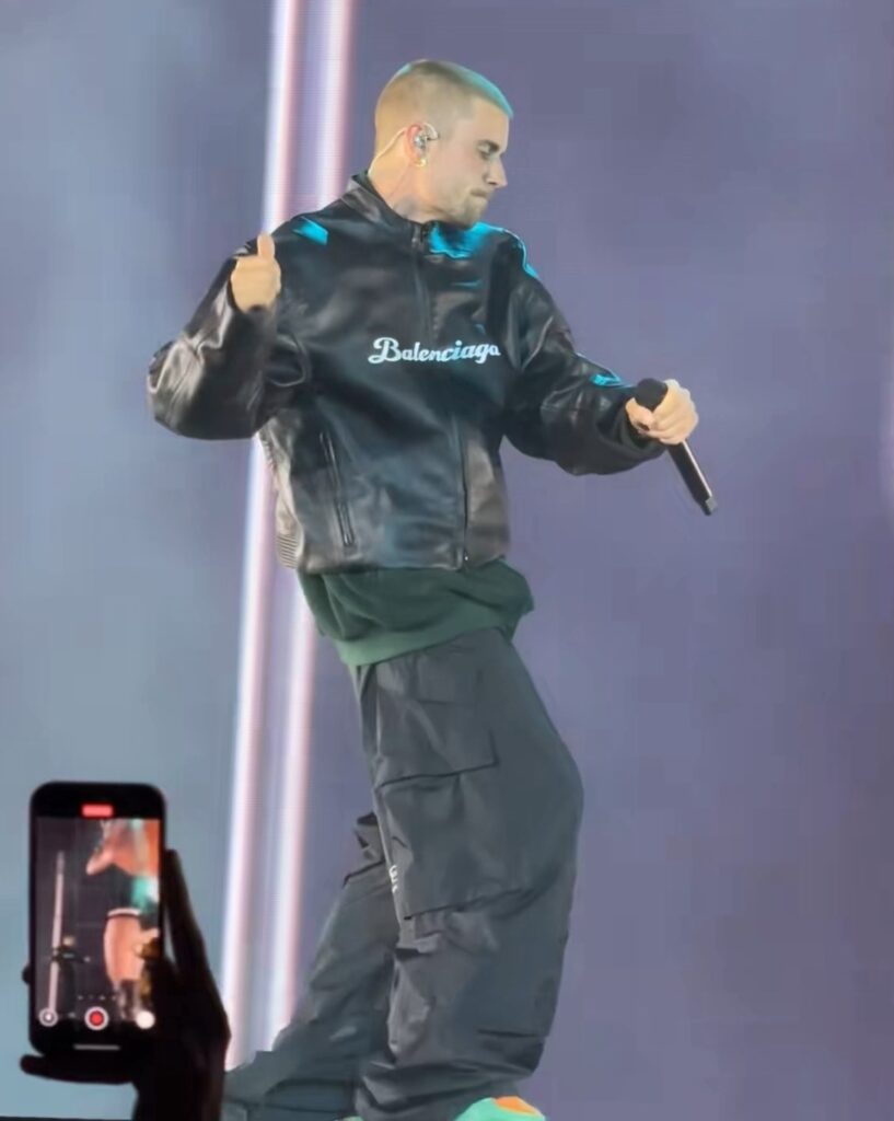 Justin Bieber performs on stage during SZA’s Los Angeles tour stop, wearing a black Balenciaga leather jacket, cargo pants, and colorful sneakers.